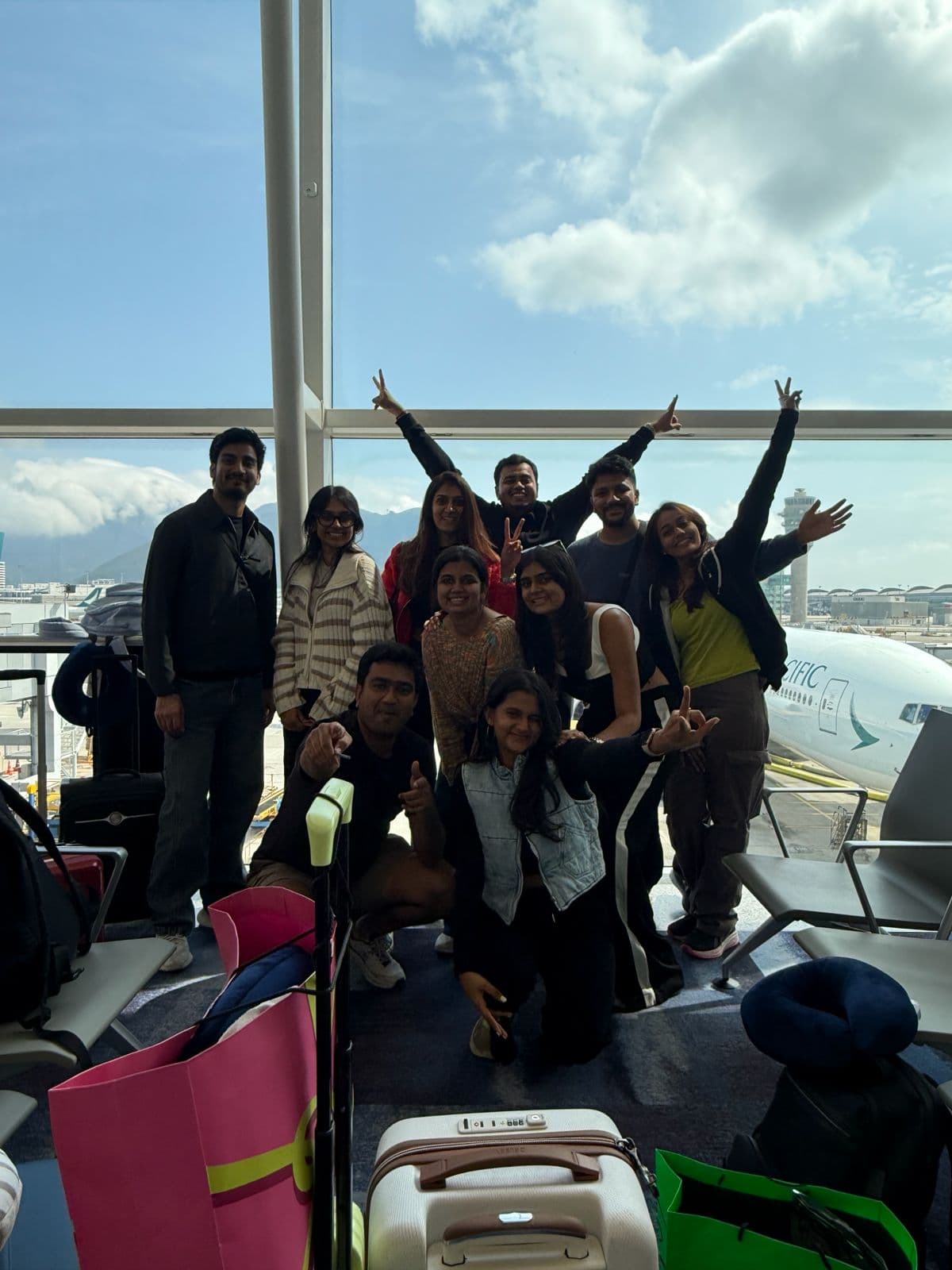 A Brew group jumping for a photo at the airport