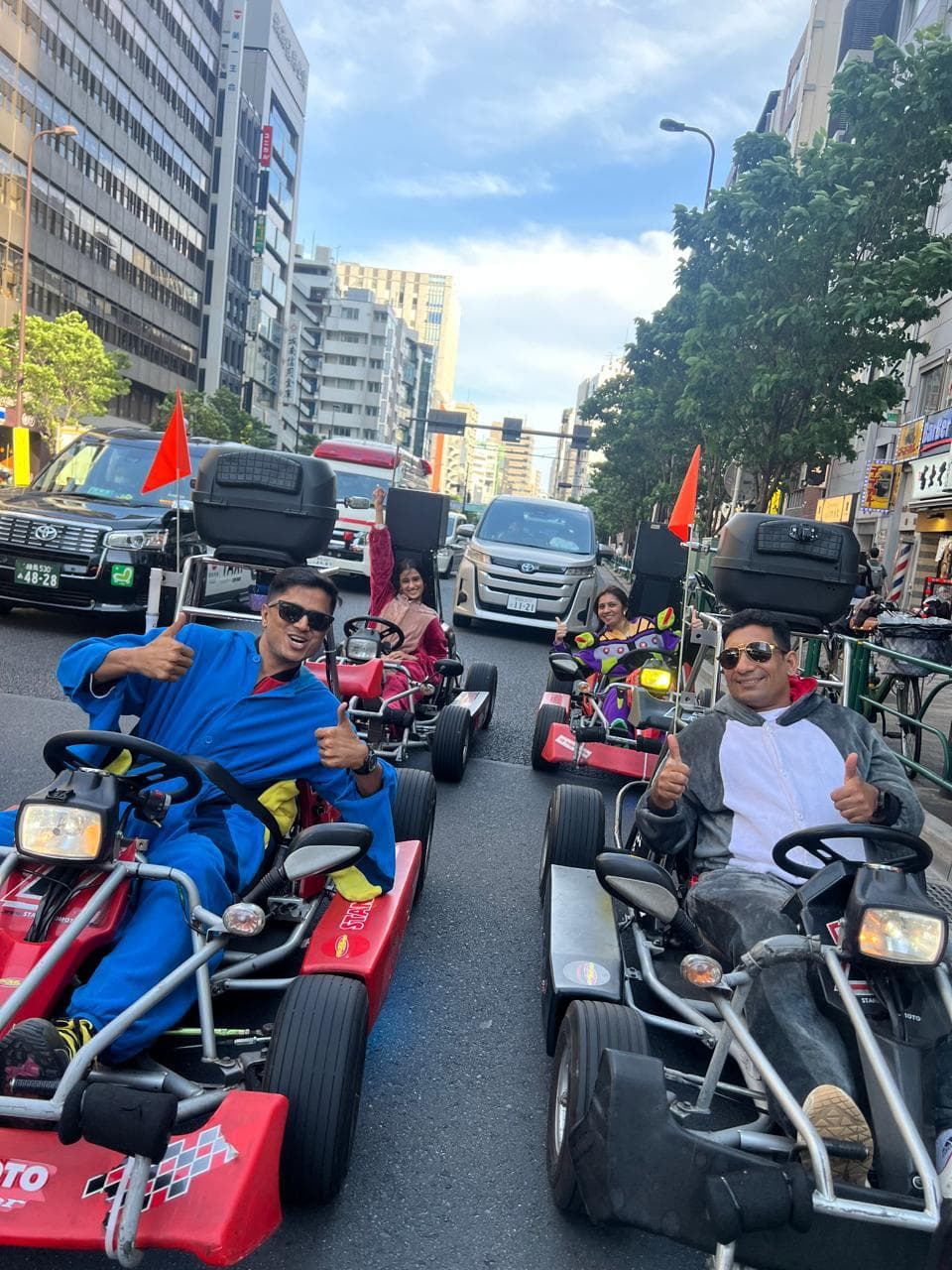 Travellers driving go-karts through Tokyo in costume